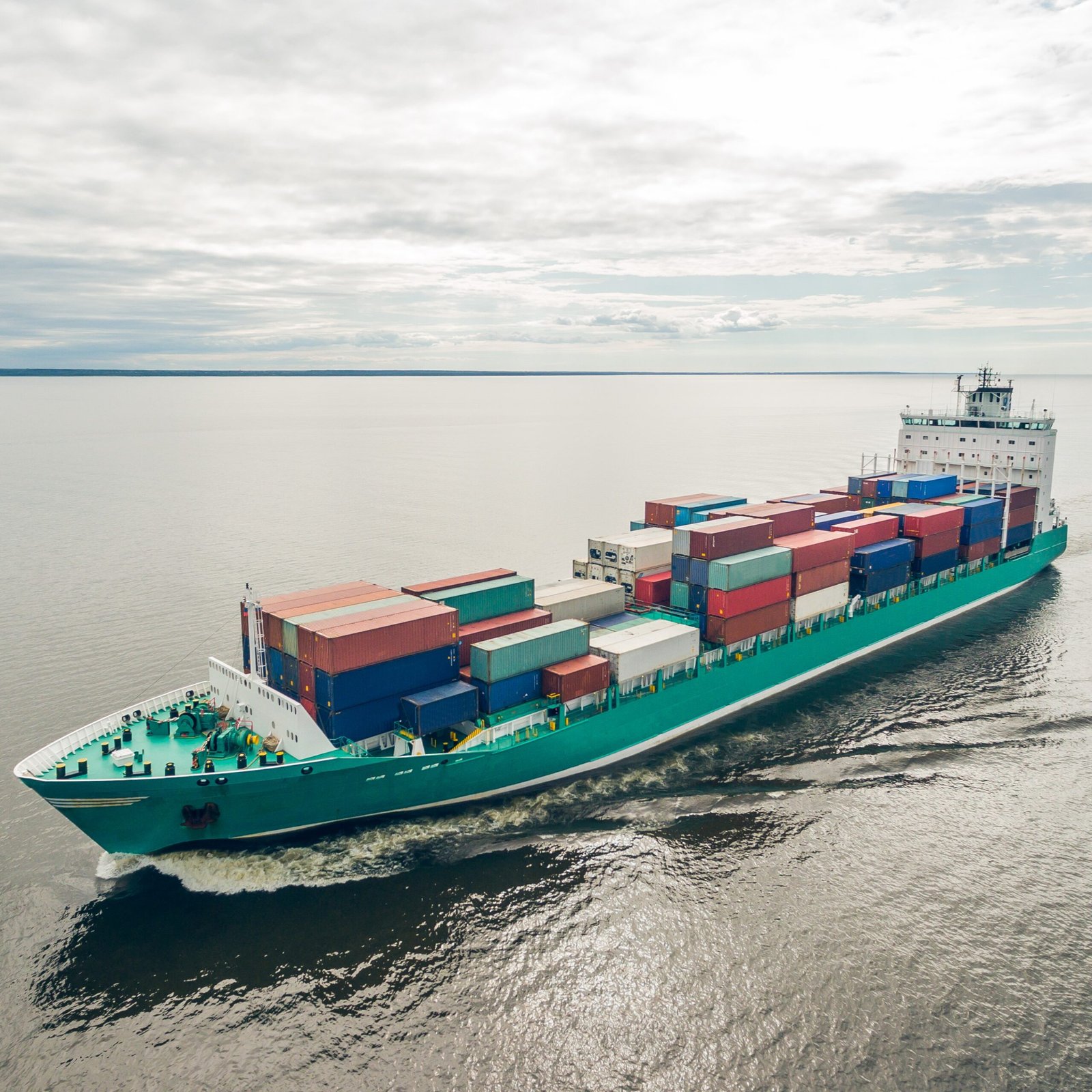 Aerial view of container vessel sailing in open sea